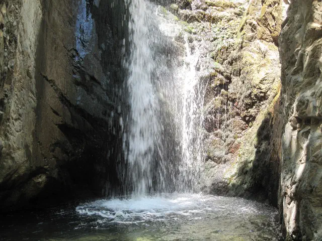 De Millomeris-waterval bij Platres stort tussen twee rotswanden in een ondiepe kom De Millomeris-waterval bij Platres stort tussen twee rotswanden in een ondiepe kom